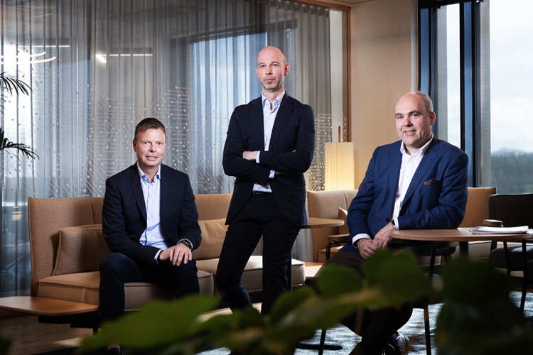 a group of people sitting at a table in a suit and tie