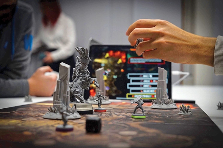 person indoor table man cake front using sitting glasses wine woman holding kitchen laptop counter young computer standing people