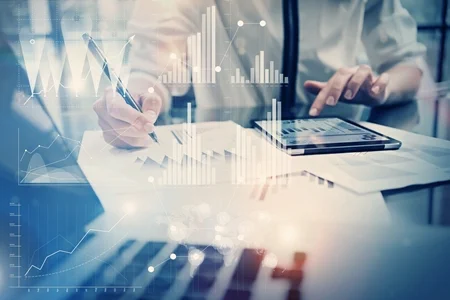 person table indoor woman food man sitting holding glasses cutting cake people room standing group